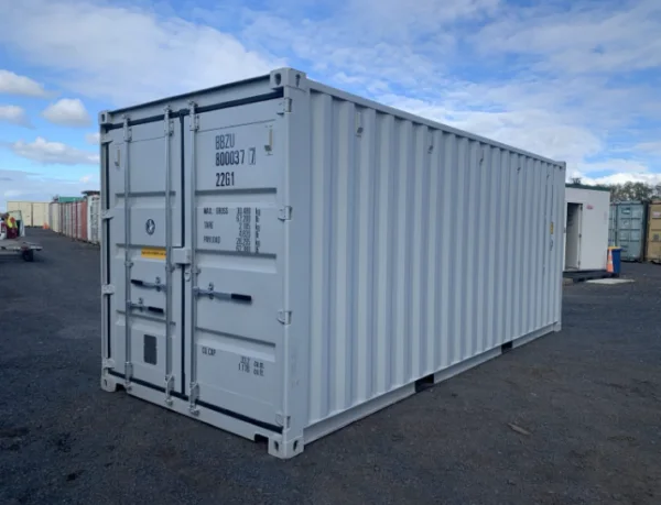 Light grey one trip 20ft container standing on a gravel yard in bright sun