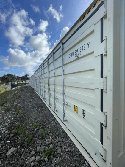Long run of side doors and locking bars on a beige open side container