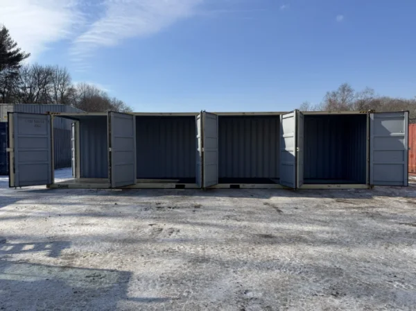 Row of beige containers standing in snow with their doors swung open