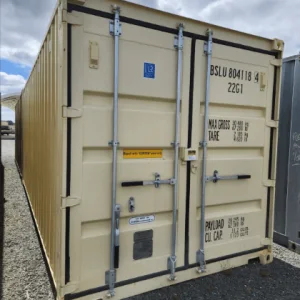 Beige 20ft container on gravel photographed square on to its cargo doors