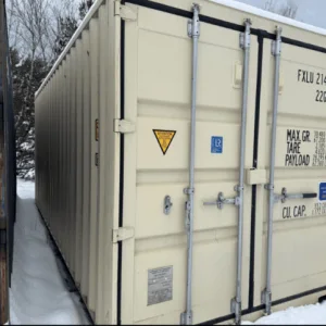 Cream 20ft container with closed cargo doors standing in snow