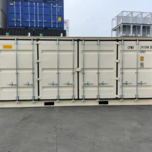Cream open side container in a depot with its side door panels closed
