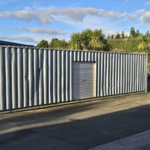 Grey 40ft container with a roller shutter door set into its long side wall