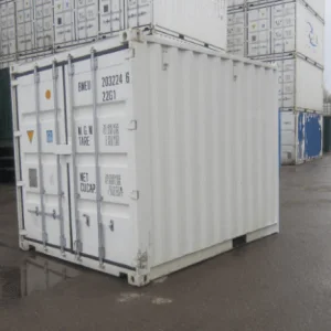 White one trip 10ft container with doors closed, standing among stacked containers