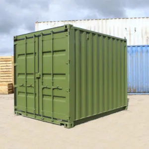 Olive green used 10ft container with S2 doors, parked beside stacked timber pallets