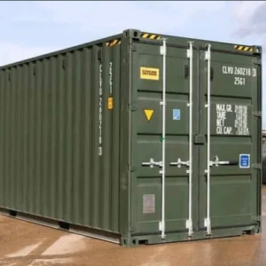 One trip green 20ft container on wet tarmac, showing its side wall and closed cargo doors