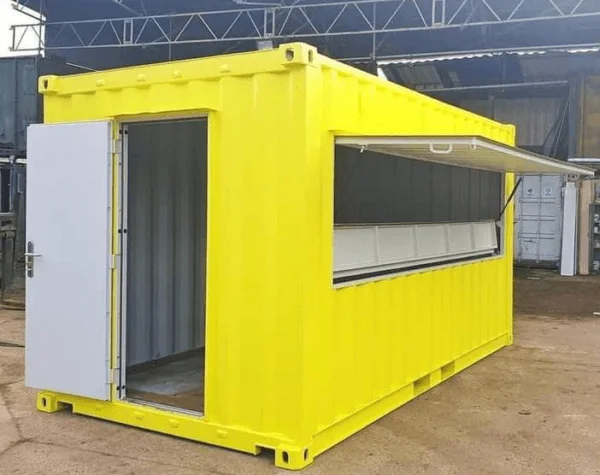 Yellow container with its serving hatch propped open and a white personnel door fitted