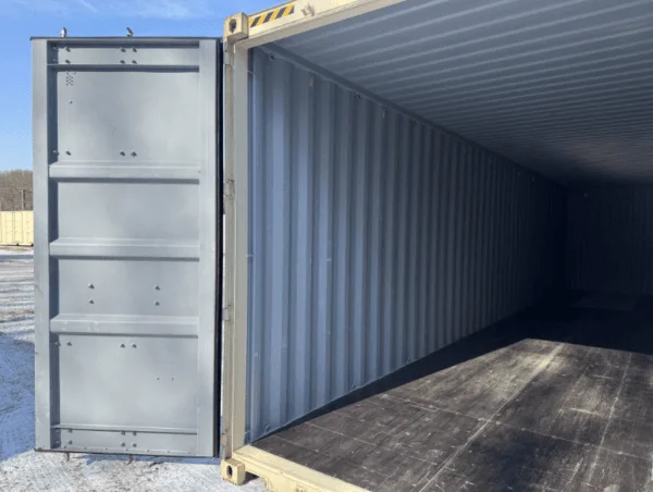 Looking into a beige container past the open door to the dark floor inside