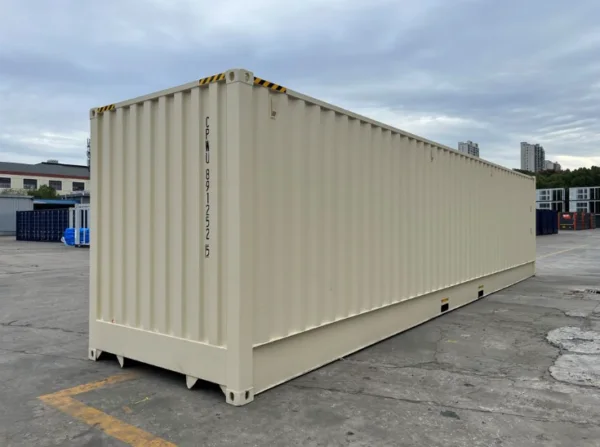 Beige 40ft container viewed from its closed end across a concrete yard