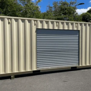 Cream 20ft container with a roller shutter door set into its side wall, shutter down