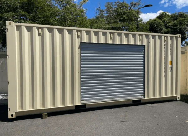 Cream 20ft container with a roller shutter door set into its side wall, shutter down