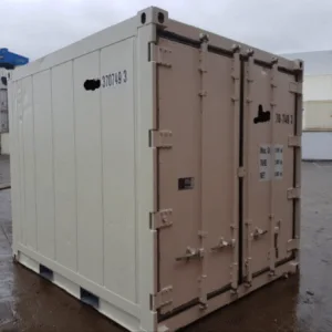 Small cream refrigerated container standing on a wet depot yard