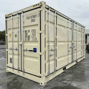 Beige open side container with its side doors closed, parked on wet concrete