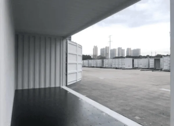 Looking the length of an open side container from inside towards the daylight