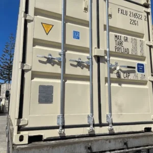 Beige 20ft container on a truck bed, photographed square on to its cargo doors