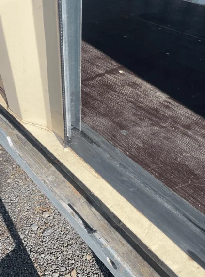 Threshold detail where the roller shutter meets the container floor edge