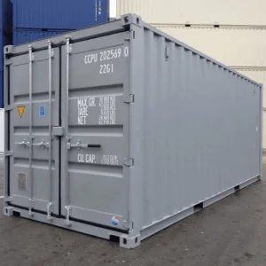 Grey container with closed cargo doors standing in a depot yard