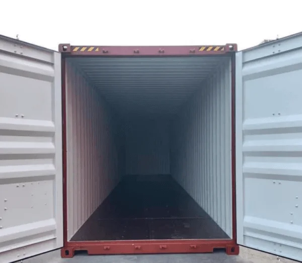 Doors open on a dark red container, looking the length of the pale interior