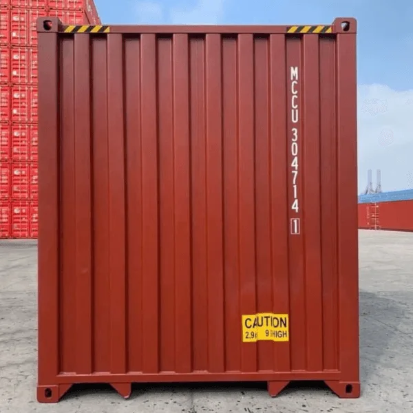 End wall of a dark red container carrying a yellow height caution decal