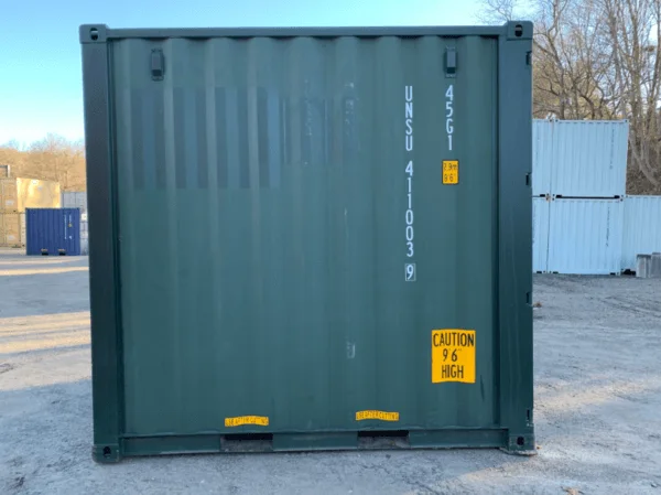 Square-on end view of a green 10ft container marked with a yellow caution decal
