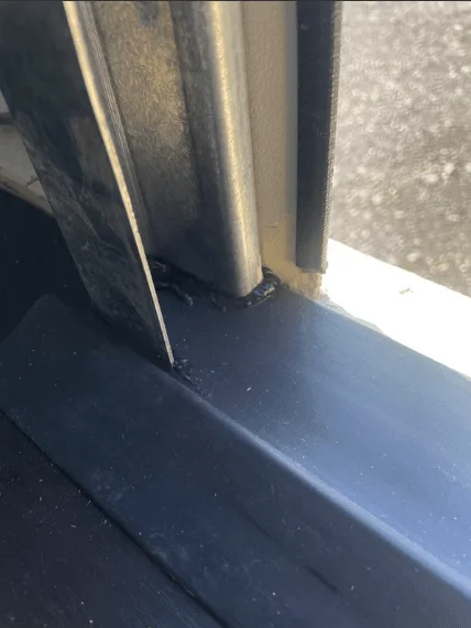 Guide channel at the edge of a roller shutter door inside a container