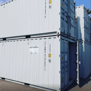 Used white 20ft containers stacked two high with one set of cargo doors standing open