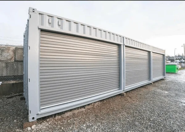White container fitted with a row of separate roller shutter doors along its side