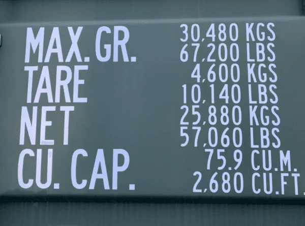Stencilled maximum gross, tare, net and cubic capacity markings on a green container wall