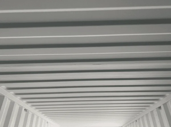 Corrugated ceiling panels seen from inside an empty shipping container