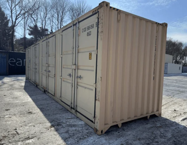 Beige high cube container seen down its length in a snow covered yard