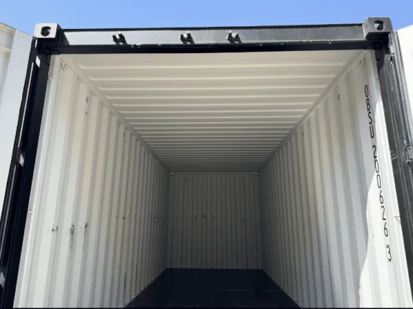 Interior of a black 20ft container looking along the ribbed walls towards the far end
