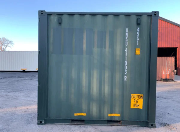End elevation of a green 10ft container with a yellow caution decal on the lower corner