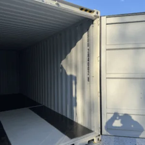 White high cube container with a door swung open, showing the shadowed interior