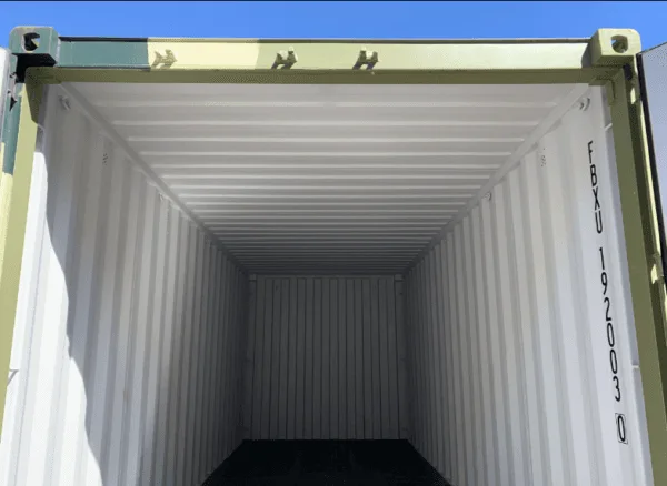 Looking down the length of a camouflage container's empty pale interior