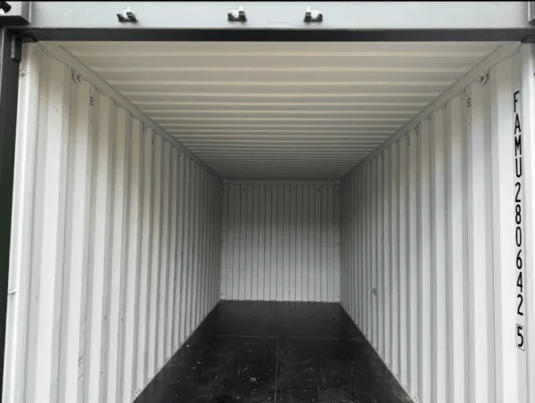 Empty interior of a 20ft container with pale walls running to the closed end