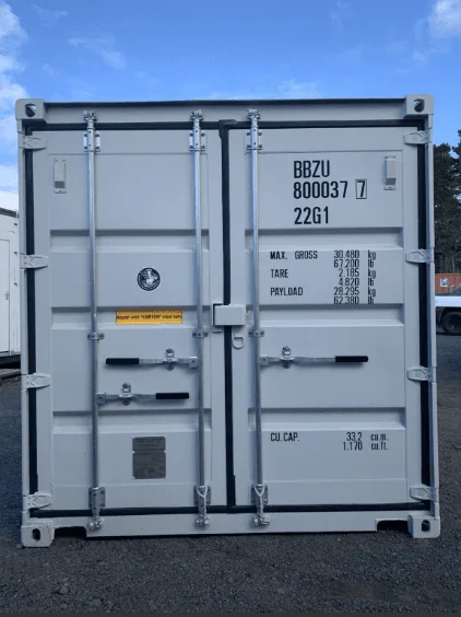 Light grey 20ft container photographed square on to its closed cargo doors