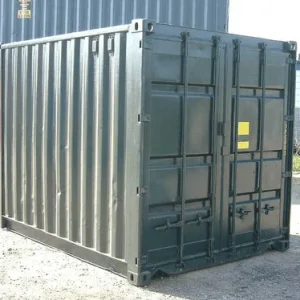 Dark grey 10ft container on gravel, seen from the corner with its cargo doors to the right
