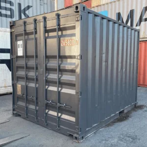 Cut down used container in dark grey, viewed from the cargo door end in a storage yard