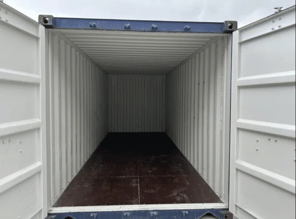 Looking through the blue door frame along an empty container interior to the far doors