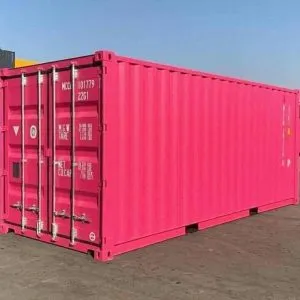 Bright pink 20ft container standing in a depot yard, seen from the door corner
