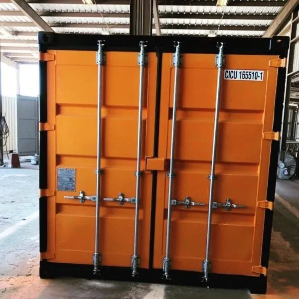Orange 40ft container inside a shed with its cargo doors closed and barred