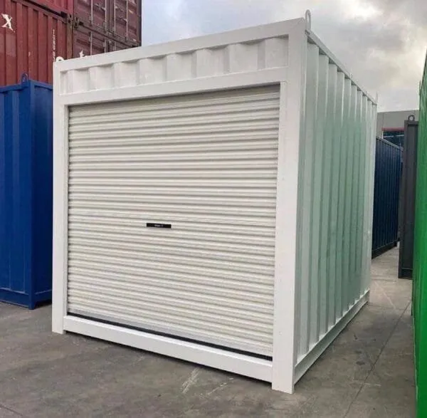 Pale green 10ft container fitted with a white roller shutter door, standing in a container yard